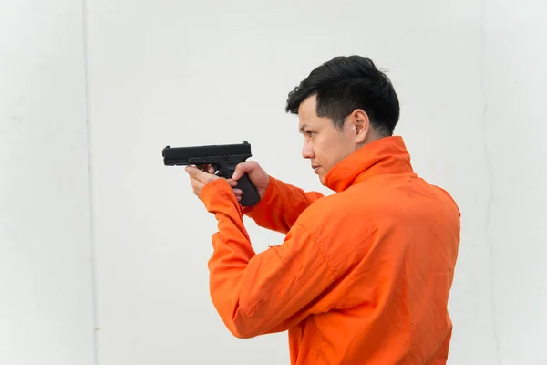 Bandit with gun in hand on white background,Thailand people,Prisoner concept