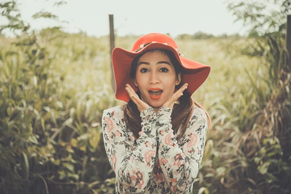 Portrait of Beautiful thai woman scared,wear red hat,Yawn,pastel tone,vintage,film