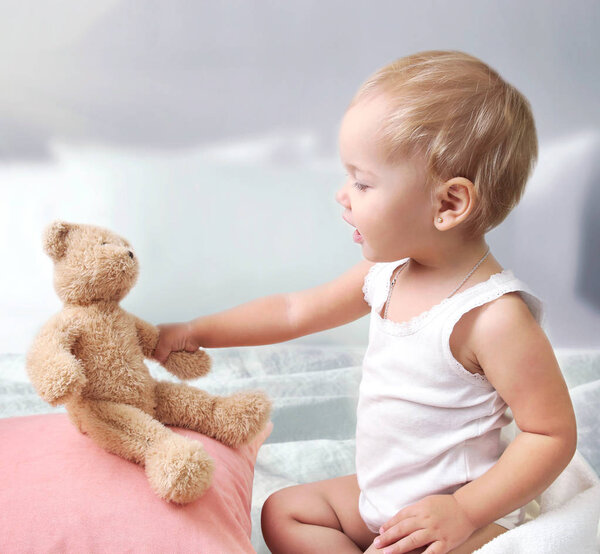 Child girl playing with teddy bear, baby with toy.Communication concept
.