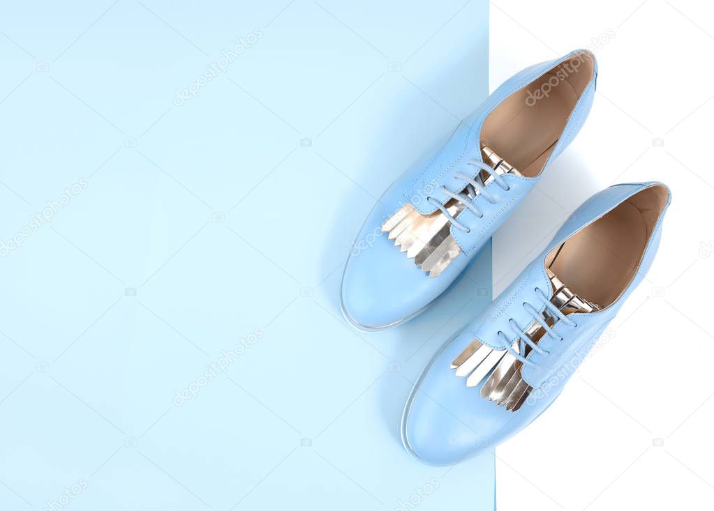 Blue flat leather lady shoes with laces top view empty space background.Fashion women's footwear.