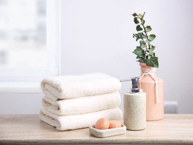 Beyaz terry havlu ve sabun ahşap masa boş alan arka plan üzerinde yığını. Duş vücut bakım kavramı.