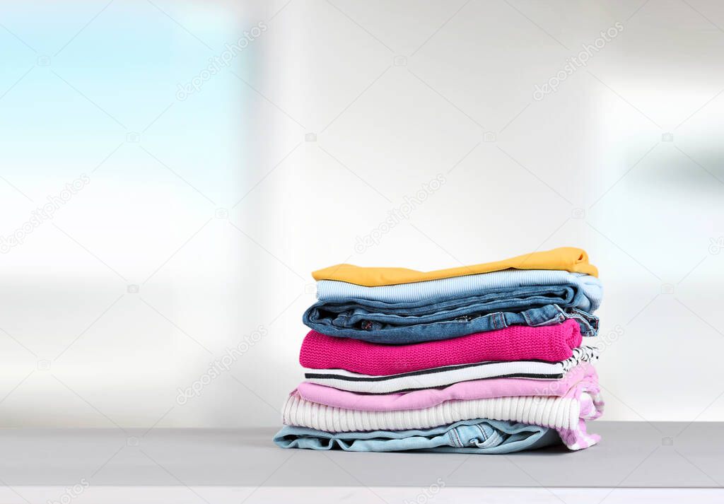 Stack of colorful clothing,cotton folded clothes stacked.Apparel on table empty copy space.Household.