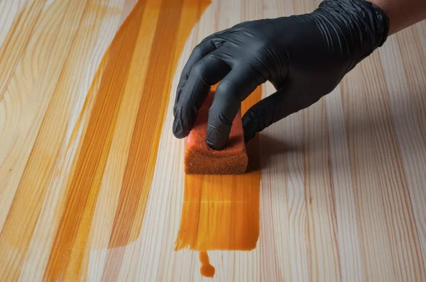 Hand Black Glove Paints Painting Kitchen Sponge Wooden Table Treatment — Stock Photo, Image