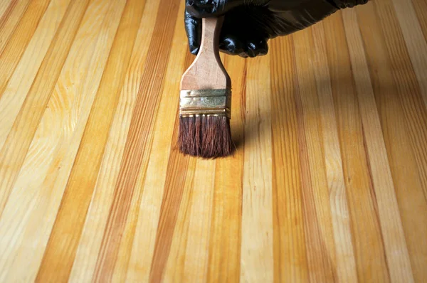 Hand Black Glove Paints Painting Brush Wooden Table Treatment Wooden — Stock Photo, Image