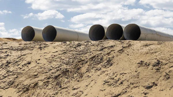 Sand and pipes at a construction site — Stock Photo, Image