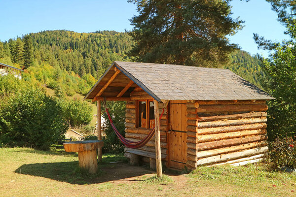 Closed log cabin on the beautiful mountainside