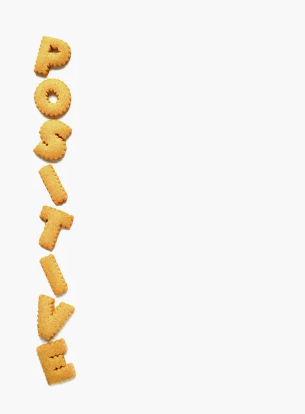 Word Positive Made Alphabet Shaped Biscuits White Background Vertical Photo — Stock Photo, Image