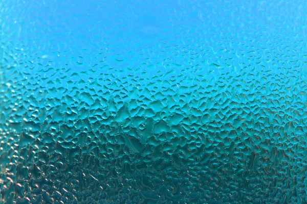 绿松石蓝色玻璃上天然水滴的宏观照片 用于有选择性聚焦的抽象背景 — 图库照片
