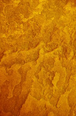 Pop sanatının altın rengi, kaba taş yüzey dokusu.