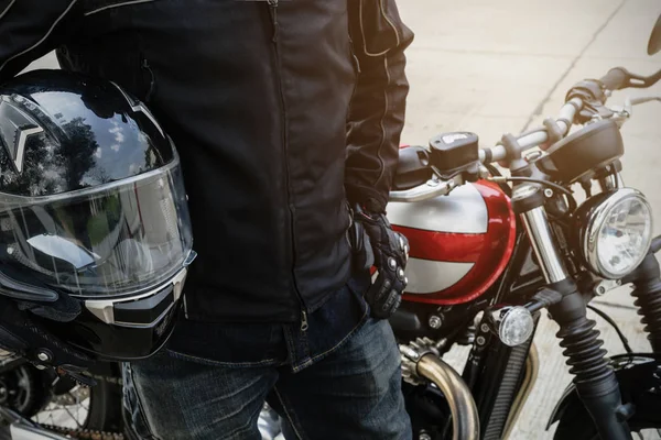 Biker wear jacket suit hold helmet with retro motorcycle — Stock Photo, Image