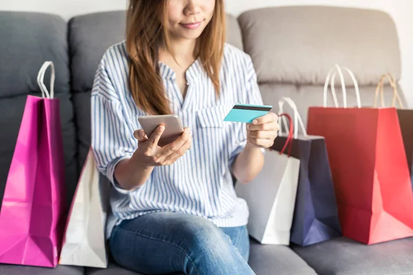 Gelukkig Aziatische vrouw met credit card en slimme telefoon — Stockfoto