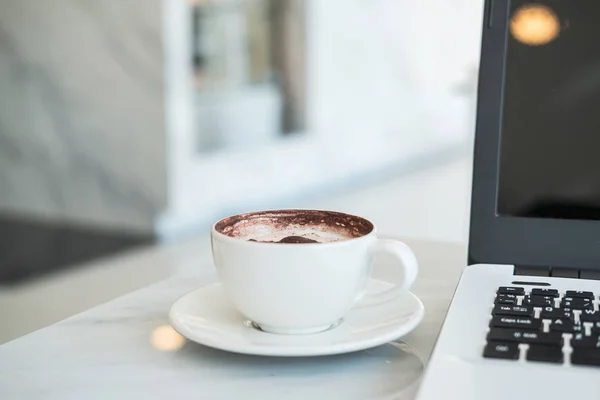 Laptop mit Tasse Kaffee im Café — Stockfoto