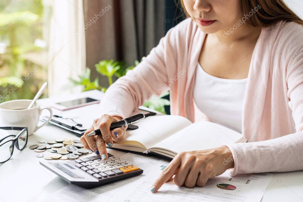 Stressed young woman calculating monthly home expenses, taxes, bank account balance and credit card bills payment, Income is not enough for expenses.