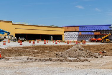 Kokomo - Circa May 2018: New strip mall construction. Even with competition from the internet, brick and mortar stores are still in demand II clipart
