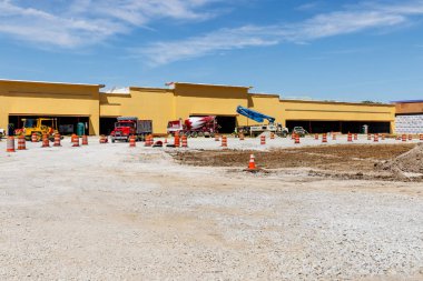 Kokomo - Circa May 2018: New strip mall construction. Even with competition from the internet, brick and mortar stores are still in demand III clipart