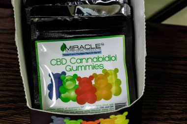 Indianapolis - Circa March 2019: Miracle Nutritional Products CBD Cannabidiol Gummies. The popularity of CBD oil as a medicinal product has skyrocketed XIII clipart