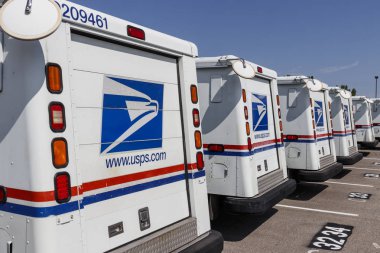 Indianapolis - Circa August 2019: USPS Post Office Mail Trucks. The Post Office is responsible for providing mail delivery VIII clipart