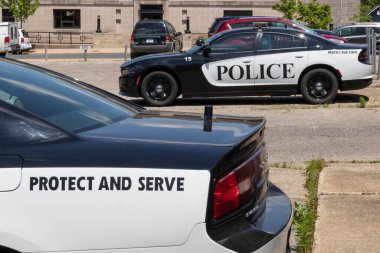 Logansport - Circa June 2020: Police cars with the words Protect and Serve. Actions by the police have resulted in calls to defund police departments. clipart