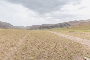 Dry Mongolian landscapes in the Altai Mountains, wide landscape. clipart