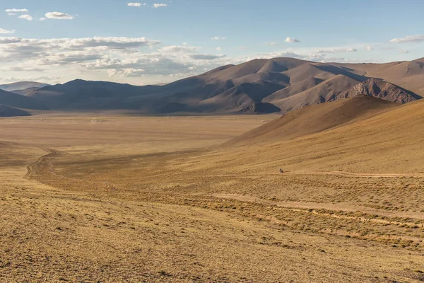 Typical view of Mongolian landscape. Mongolian Altai, Mongolia, Mongolian nomad on a motorcycle