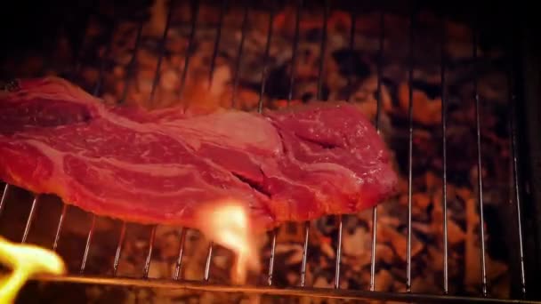 Raw Piece Beef Steak Barbecue Grill Faint Coals Flames Foreground — Stock Video