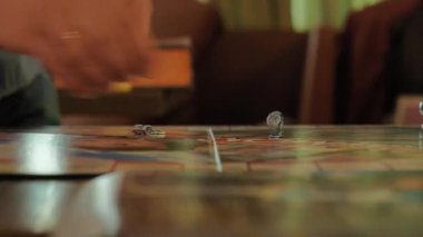 Monopoly oynayan insanların ellerini yakın plan çekeceğiz..