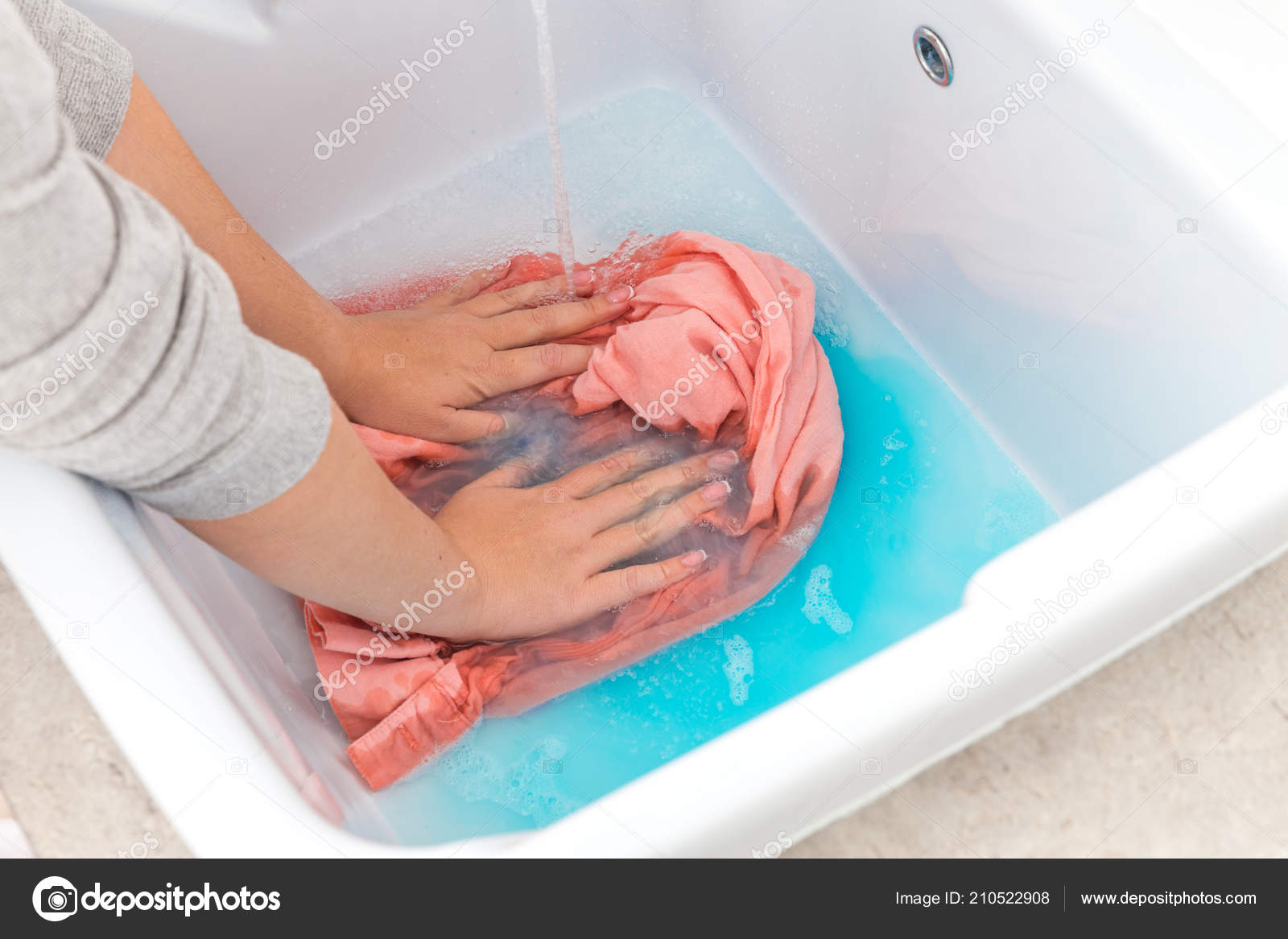 Female Hands Washing Color Clothes In Sink Stock Photo