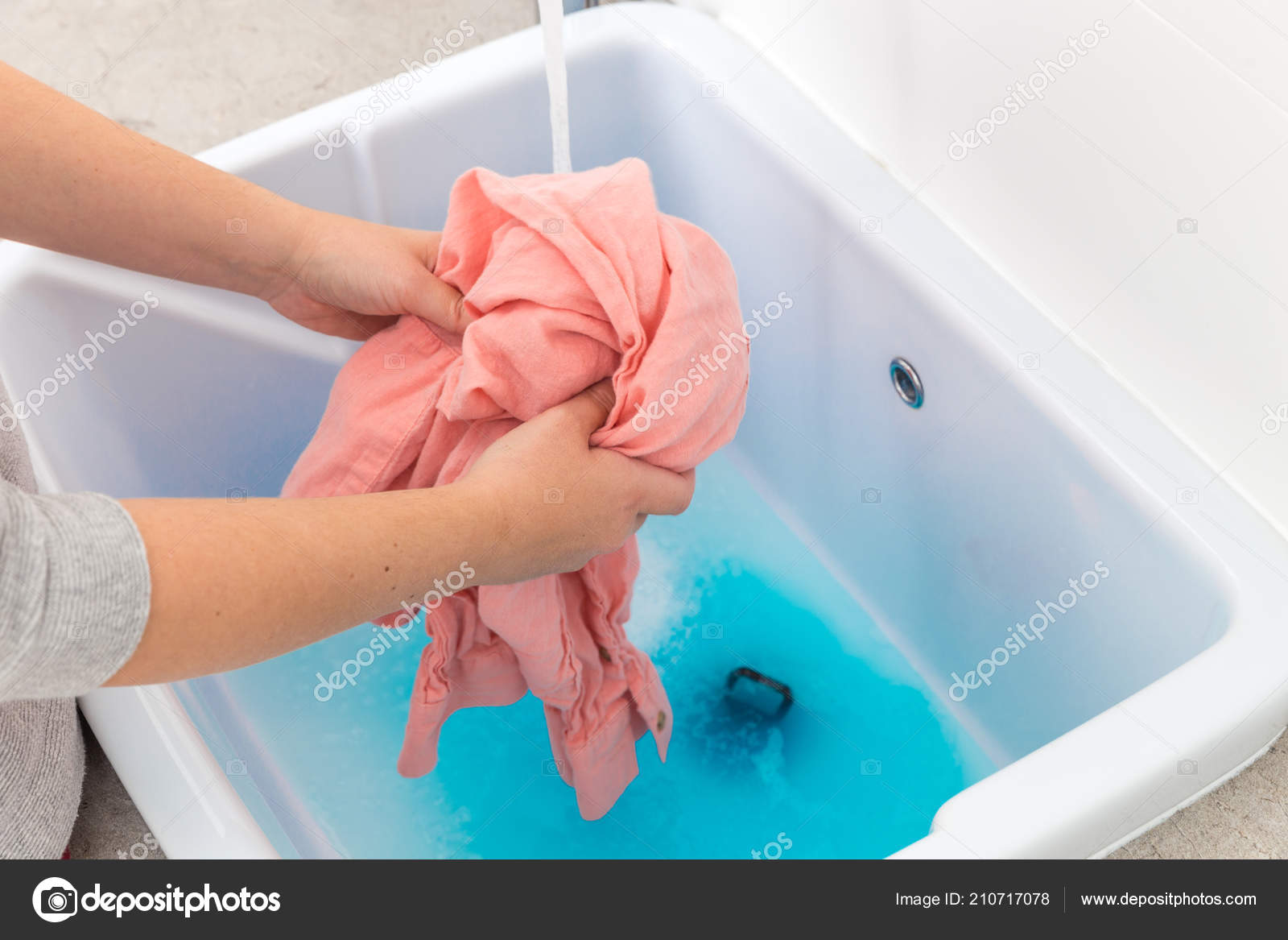 Female Hands Washing Color Clothes In Sink Stock Photo
