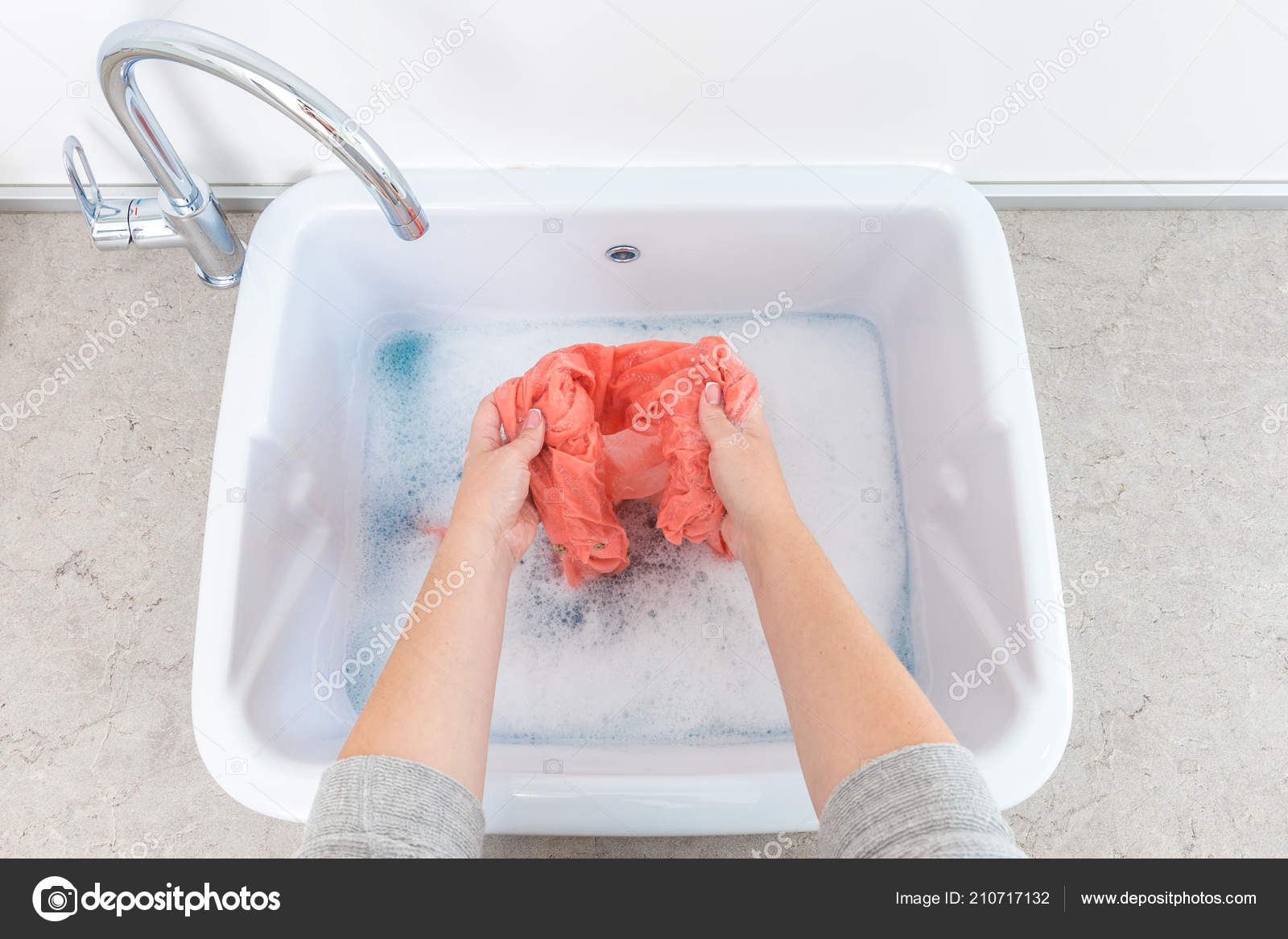 Female Hands Washing Color Clothes In Sink Stock Photo