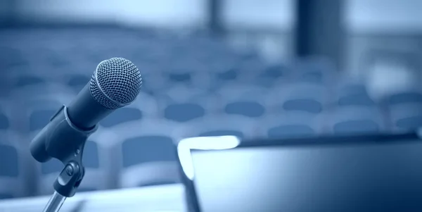 Rostrum with microphone and computer in conference room — Stock Photo, Image
