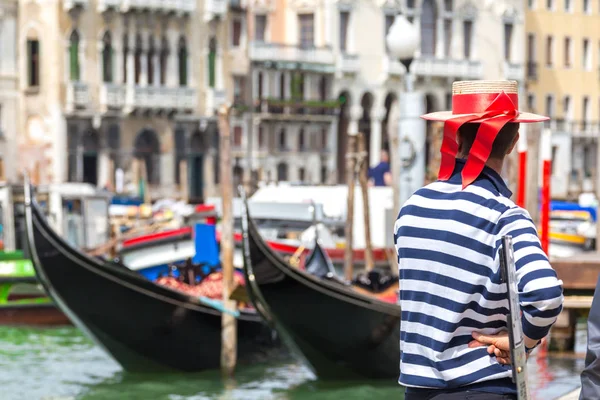 Gondolier de pé ao lado da gôndola à espera de um cliente em Veneza Itália — Fotografia de Stock