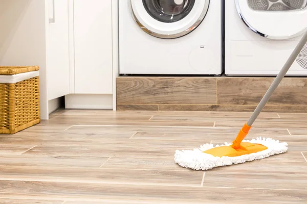 Čištění podlahy v prádelně v moderním domě — Stock fotografie