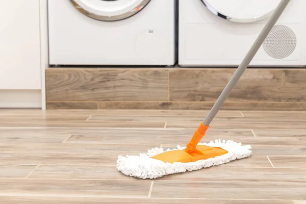 Cleaning floor in laundry room in modern house — Stock Photo, Image