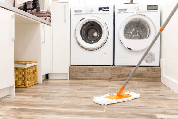 Cleaning floor in laundry room in modern house — Stock Photo, Image