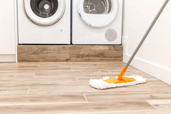 Cleaning floor in laundry room in modern house — Stock Photo, Image