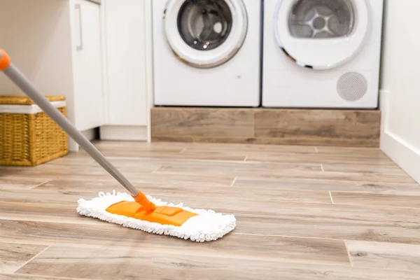 Cleaning floor in laundry room in modern house — Stock Photo, Image