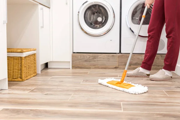 Cleaning floor in laundry room in modern house — Stock Photo, Image