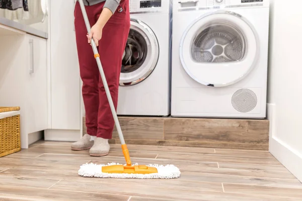 Cleaning floor in laundry room in modern house — Stock Photo, Image