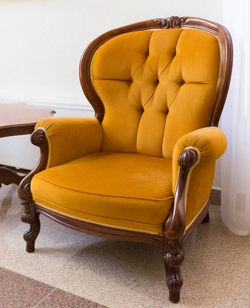 Antique orange armchair, vintage old style armchair
