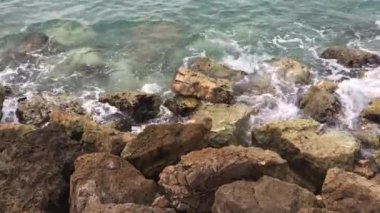 Güçlü dalgalar taşların üzerinde sıçramasına. Kayalık sahil isabet dalgalar deniz. Kayalar karşı sıçramasına okyanus