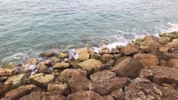 Fuertes olas salpicando sobre piedras. Las olas del mar golpean la costa rocosa. Océano salpicando contra rocas — Vídeo de stock