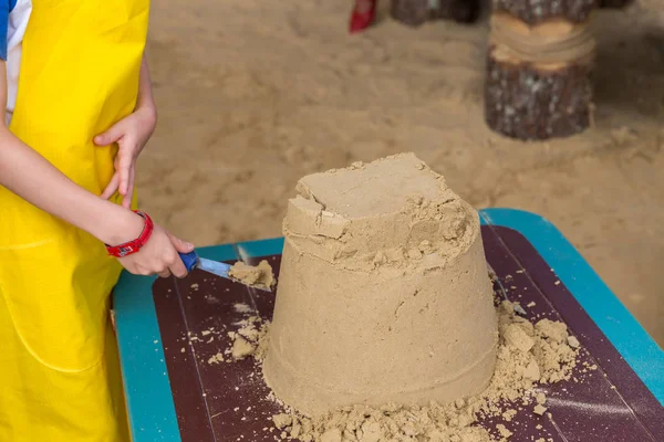 Sand castle made by kids on a craft lesson on beach