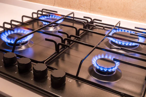 Gas burner on black modern kitchen stove — Stock Photo, Image