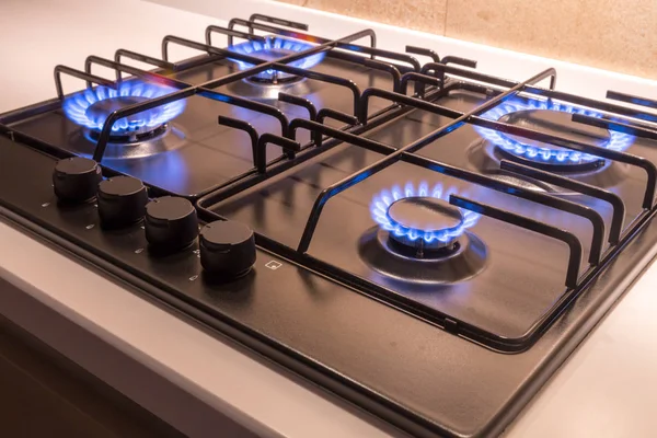 Gas burner on black modern kitchen stove — Stock Photo, Image