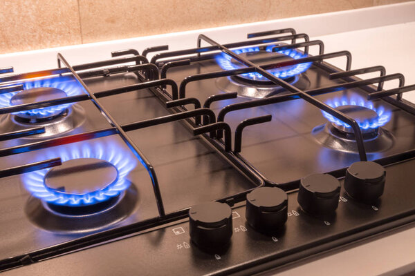 Gas burner on black modern kitchen stove