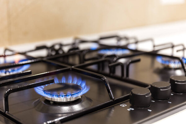 Gas burner on black modern kitchen stove