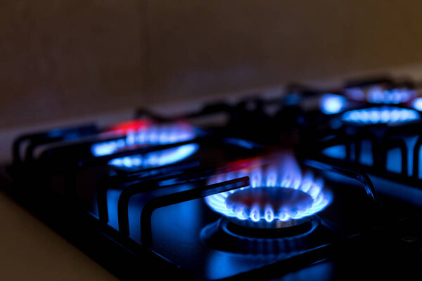 Gas burner on black modern kitchen stove