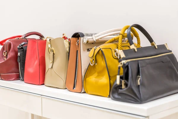 Collection of handbags standing in a row