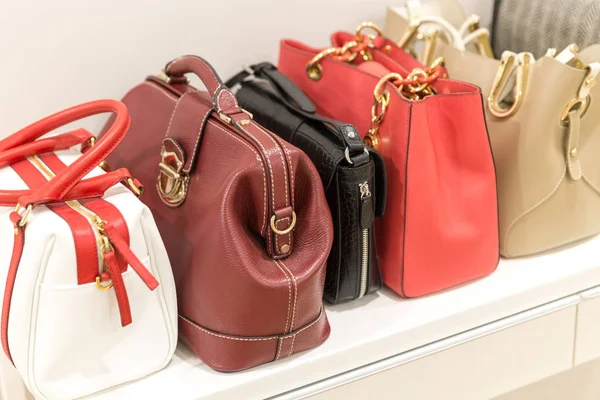 Collection of handbags standing in a row