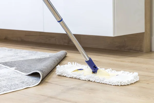 Wooden floor with white mop, cleaning service concept — Stock Photo, Image